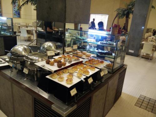 a buffet with many different types of pastries on display at Sayaji Indore in Indore