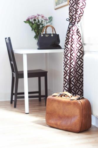 a suitcase sitting on the floor next to a table at Pensionat Augustin in Gällivare