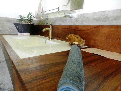 a bathroom with a sink and a persons foot on the floor at The Ibis - Wilpattu in Puttalam