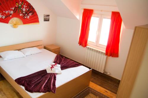 a small room with a bed and a window at Airport Apartments in Belgrade
