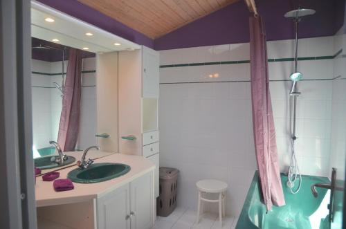 une salle de bain avec un lavabo, une douche et une baignoire dans l'établissement Maison de vacance au coeur du village, à Saint-Trojan-les-Bains