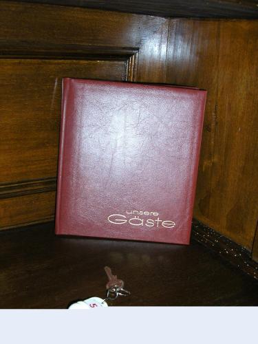 a red book sitting on top of a table at Pension Villa Beer in Stralsund