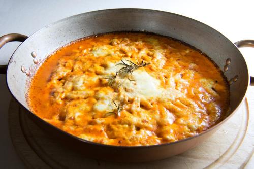a pan filled with soup with cheese and dill at Hotel il Castelletto in Casarile