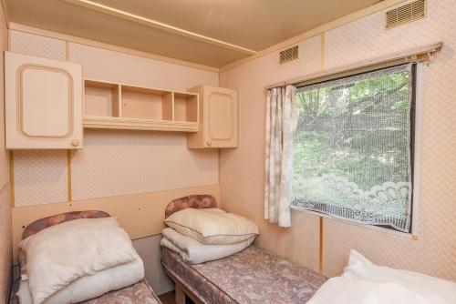 a small room with two chairs and a window at Camping Mindunai in Mindūnai