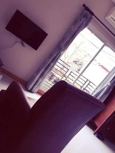 a living room with a couch and a large window at Hua Hin White Sand in Hua Hin