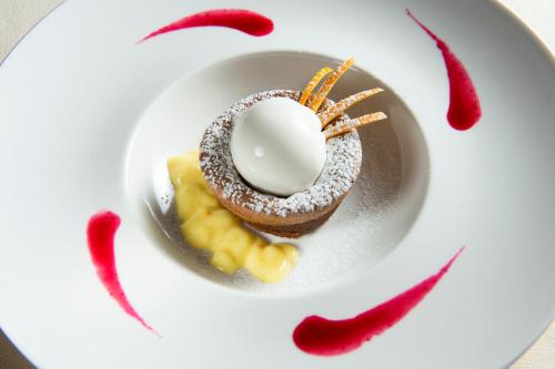 a plate with a chocolate doughnut with a egg on it at Hotel il Castelletto in Casarile