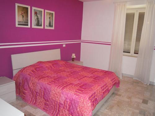 フォンディにあるCasa Lia - Climbing Houseの紫色のベッドルーム(ピンクの掛け布団付きのベッド付)
