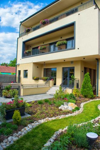 a building with a garden in front of it at Nora Prestige in Timişoara