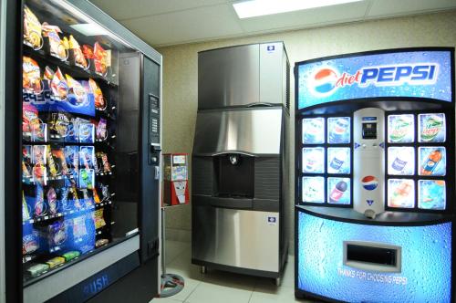 a soda machine in a store next to a refrigerator at Baymont by Wyndham Lafayette - Purdue University in Lafayette