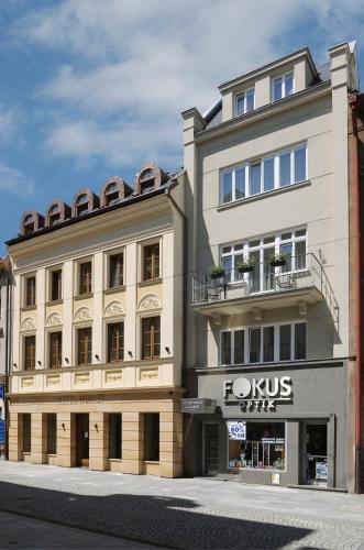 a large white building with a sign on it at Apartmány Kramer in Opava