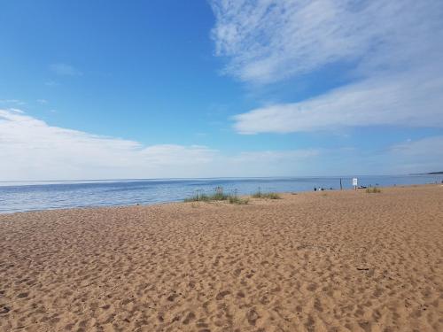 a sandy beach with the ocean in the background at Pinedune Beach in Saulkrasti