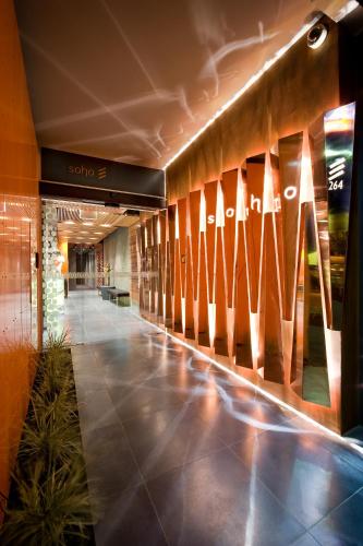 a hallway with surfboards on a wall in a building at The Soho Hotel in Adelaide