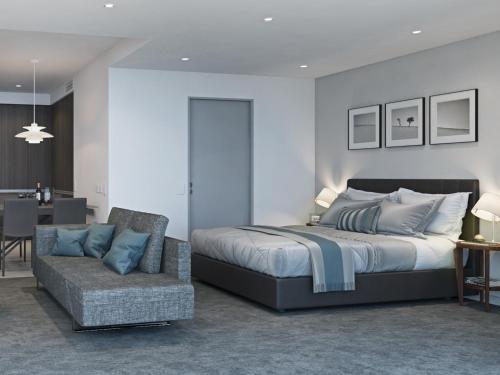 ein Schlafzimmer mit einem Bett und einer Couch in der Unterkunft The Branksome Hotel & Residences in Sydney