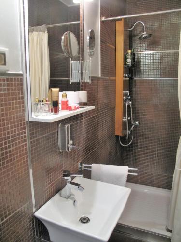 a bathroom with a sink and a shower and a mirror at Studio Apartment Sofia - Poreč Old Town Quiet Oasis with FREE parking in Poreč