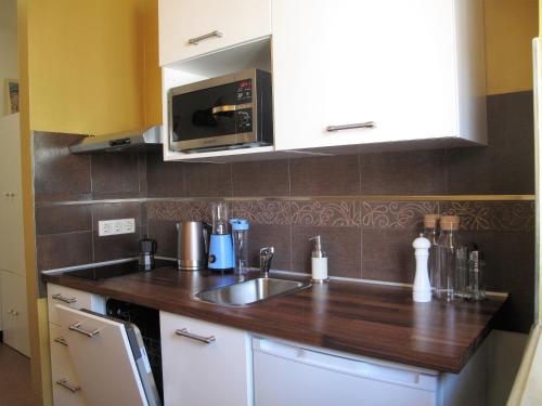 a kitchen with a sink and a microwave at Studio apartment Sofia in Poreč