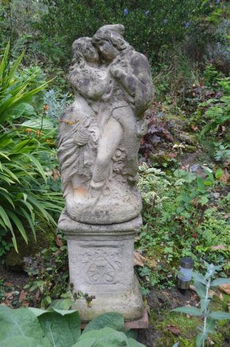 a statue of a child on a pillar in a garden at Thornybank in Cromer