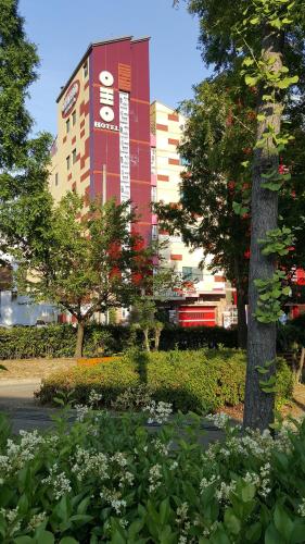 a building with a sign on the side of it at OHHO Hotel in Gimhae