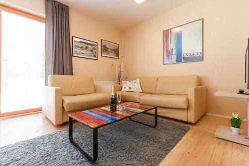 a living room with a couch and a table at Chalet6harrachov se saunou in Harrachov