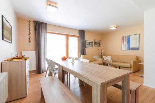 a living room with a wooden table and a dining room at Chalet6harrachov se saunou in Harrachov