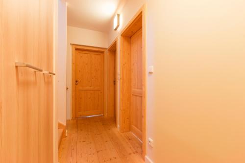an empty hallway with a door and a wooden floor at Chalet6harrachov se saunou in Harrachov