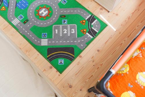a toy race track on a wooden table with a scooter at Chalet6harrachov se saunou in Harrachov