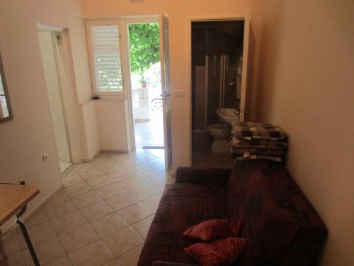 a living room with a couch and a bathroom at Apartments Morgen in Brna