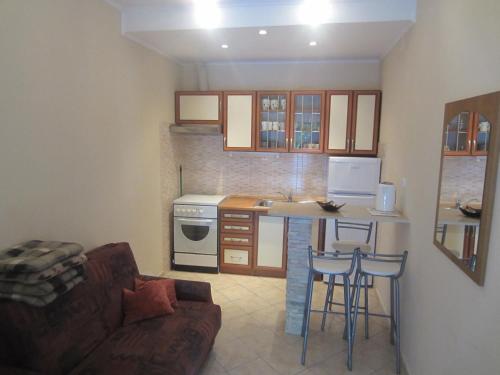 a living room with a kitchen with a couch and a table at Apartments Morgen in Brna