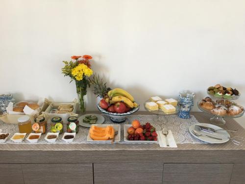 a buffet of fruits and vegetables on a table at Alludo Aparthotel b&b in Agrigento