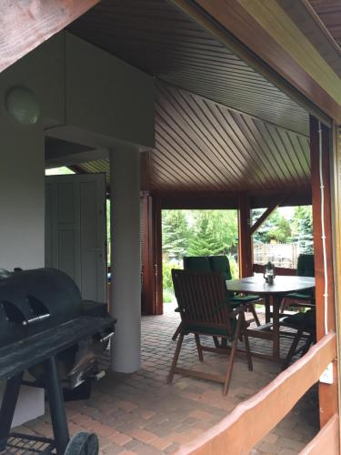 a screened in porch with a table and chairs at 4 D klima in Licheń