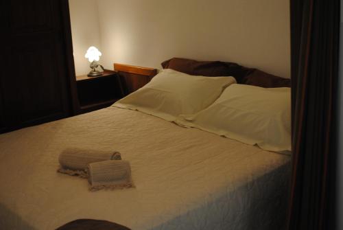 a bedroom with a large bed with white sheets and pillows at Trullo Pietraluna in Martina Franca