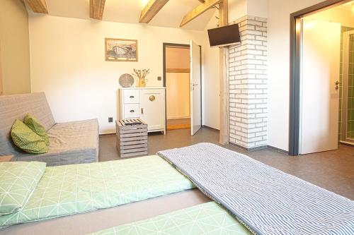a living room with a couch and a television at Penzion Only in Kunějov