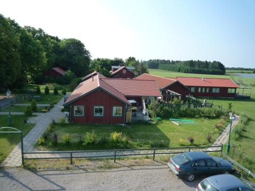 a red house with cars parked in front of it at Freja Vandrarhem in Vreta Kloster