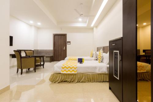 a hotel room with a bed and a dining room at Hotel Southern Residency- near to SIPCOT in Kelambākkam
