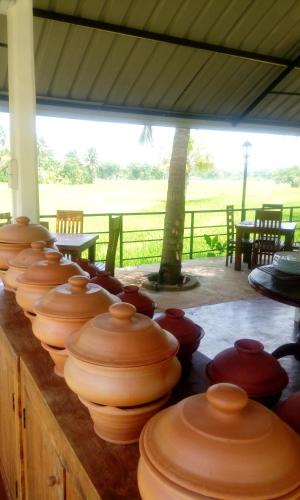 a row of wooden bowls on a wooden table at Rajarata Family Resort in Anuradhapura