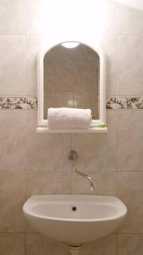 a bathroom with a sink with a light above it at Paradiso Apartments - Liman1 in Ulcinj