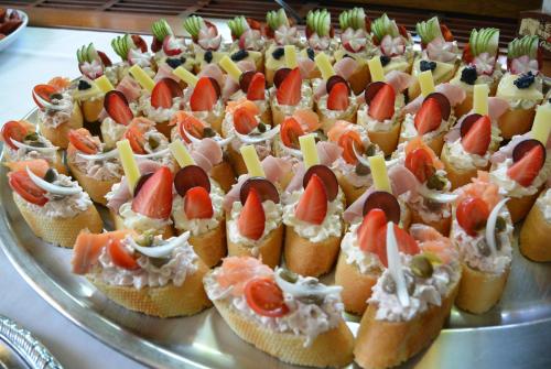 a bunch of appetizers on a silver platter at Hotel Best in Ostrava