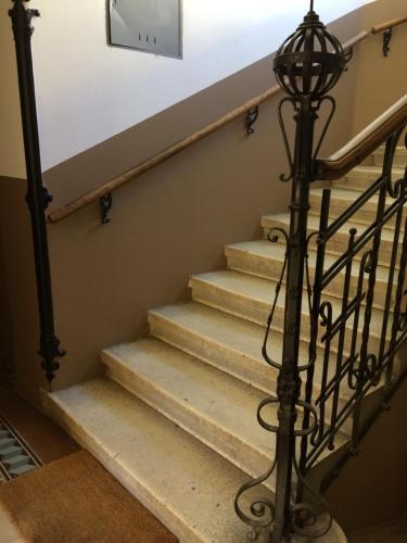 a set of stairs with a clock on the wall at Apps 21 in Vienna