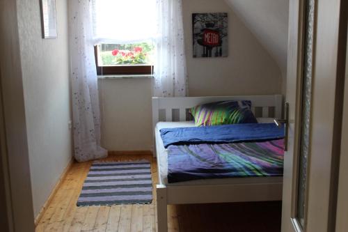 a small bedroom with a bed and a window at Ferienhaus Erholungsparadies im schönen Franken in Obertheres