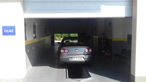 a small car is parked inside of a garage at Apartments Delić in Nikšić