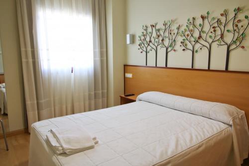 Postel nebo postele na pokoji v ubytování Hostal Restaurante Taracena