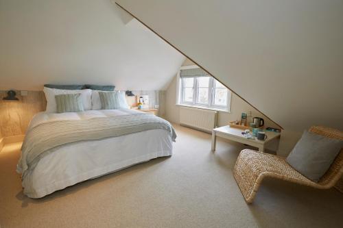 a bedroom with a large bed and a chair at Lyndhurst House in Lyndhurst