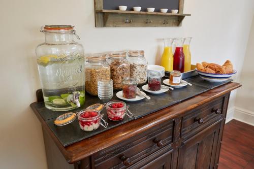 a table with jars of food on top of it at Lyndhurst House in Lyndhurst