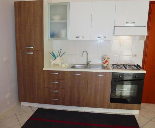 a kitchen with a sink and a stove at Casa Margherita piano primo in Mondragone