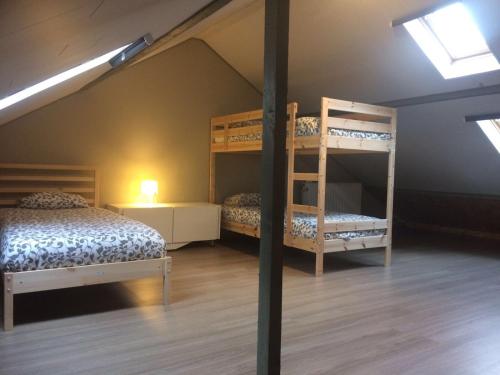 a room with two bunk beds in a attic at La Petite Villa in Spa