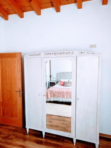 a white cabinet with a bed in a room at Agroturismo Ondarre in Segura