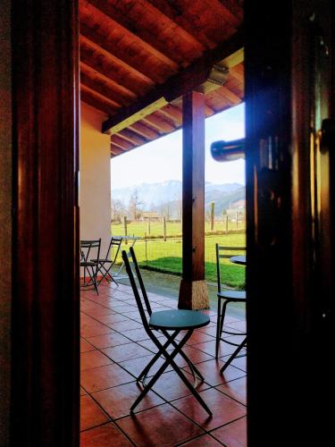 a porch with chairs and a view of a field at Agroturismo Ondarre in Segura