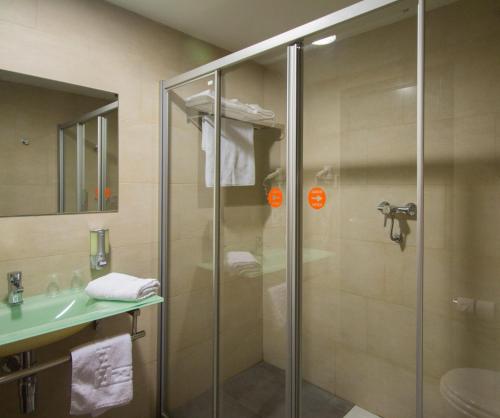 a glass shower in a bathroom with a sink at H2 Fuenlabrada in Fuenlabrada