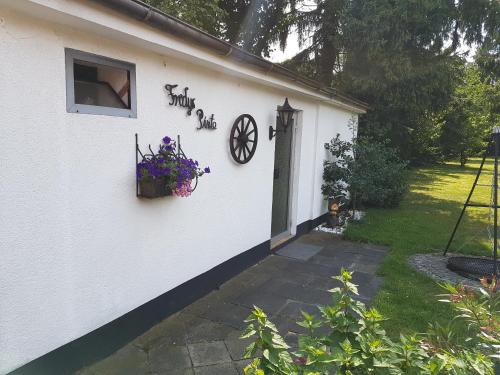 a white building with a window and a clock on it at Opdenberg in Düsseldorf