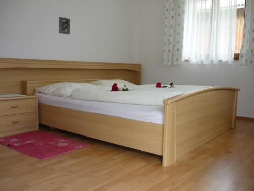 a bedroom with a bed with two roses on it at Oberrainbauer in Kleinarl