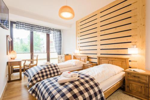 Posteľ alebo postele v izbe v ubytovaní Apartamenty Oaza Deluxe Zakopane